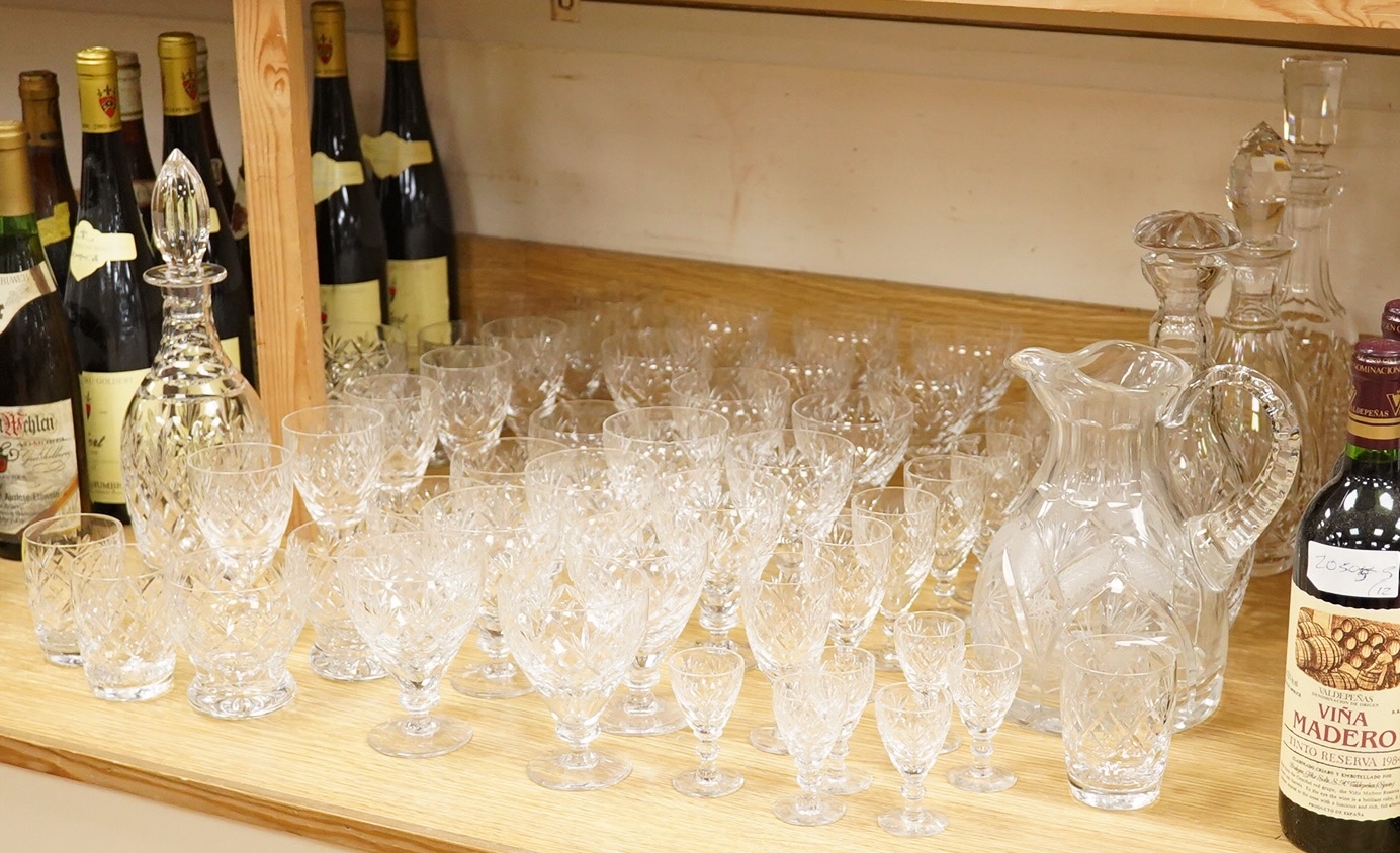A collection of Webb cut glass suites and four decanters, together with a glass jug, largest 35cm high